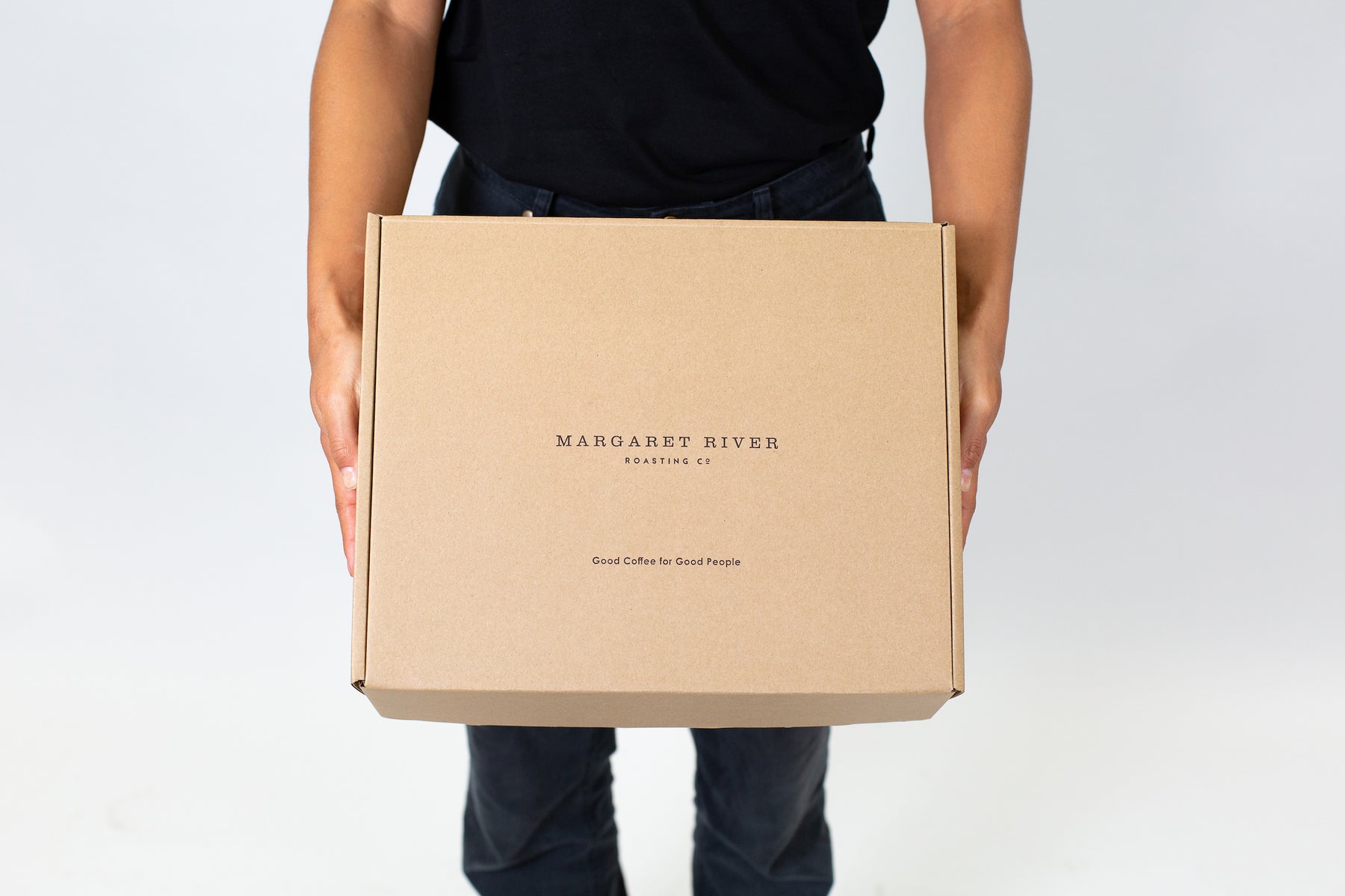 man holding a subscription box for Margaret River Coffee Roasting Co. coffee